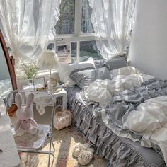 an unmade bed sitting in front of a window