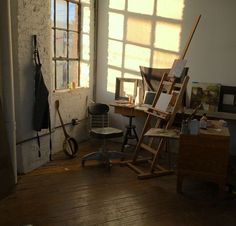 an empty room with several pieces of art on the floor