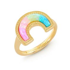 a gold ring with an opal in the middle and a rainbow colored stone on top