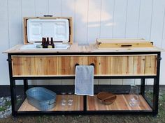 an ice chest with two coolers sitting on top of it