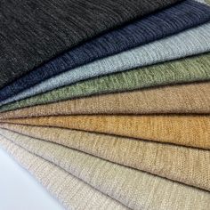 the colors of wool are arranged in rows on top of each other, including beiges and browns