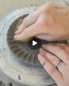 someone is working on an object in the process of making something out of clay and metal