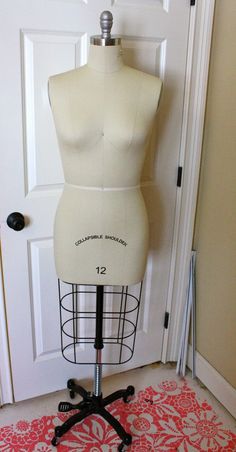 a mannequin on a stand in front of a door