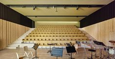 an empty auditorium with chairs and musical instruments