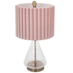 a pink lamp on a white background with a gold colored base and a round glass shade