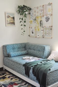 a living room with a couch, rug and pictures hanging on the wall above it