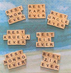 wooden scrabbles spelling best mom ever and best dad ever on a blue background