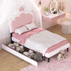 a bed with pink sheets and pillows in a room next to a white desk, mirror and teddy bear