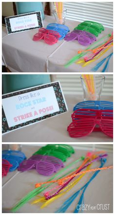 there are many different colored glasses on the table and one is in front of a sign that says rock star strike a pose