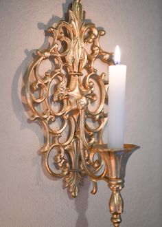 Make a Statement - Create an alluring ambiance with these stunning gothic gold candle sconces. Their rich metallic finish and dark, dramatic style will illuminate any room. With their bold vintage-inspired design, these sconces add intrigue and allure to any space. The antique gold finish and gothic accents create a luxe, moody vibe perfect for living rooms, bedrooms, and more. Flickering candlelight casts a warm, romantic glow and highlights the sconces' ornate details. Place them on either sid Beauty And The Beast Inspired Bedroom, 1800s Home Decor, Moody Chandelier, Southern Gothic Decor, Dark Academia Diy, Gold Home Accents, Gold Candle Sconces, Cross Candle, Romantic Bedroom Design