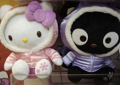 two hello kitty stuffed animals sitting next to each other