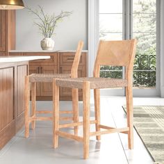 a wooden bar stool sitting next to a kitchen counter