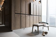 a pair of shoes sitting on the floor next to a bench in front of wooden lockers