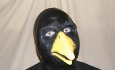 a man wearing a black mask with a yellow beak