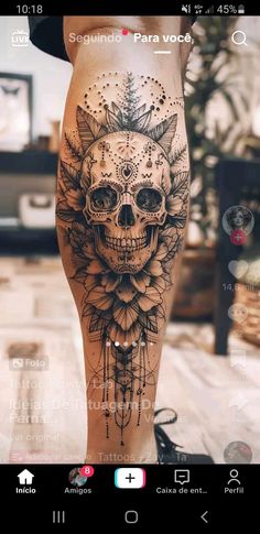 a woman's leg with a skull and flowers tattoo on it