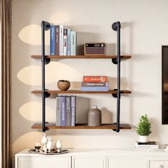 a living room with a tv, bookshelf and vases on the wall