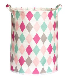 a pink, green and grey basket on a white background with the lid open to show an argyle pattern