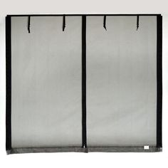 two black and white curtains are hanging on the wall next to each other with hooks