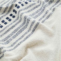 a blue and white striped towel laying on top of a bed