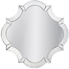 a round mirror with an intricate design on the front and back side, in silver