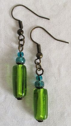 Mixed Green Dangle Earrings 1.75" in length, vibrant lime green glass and brass beaded earrings add a perfect summer accent. Made with glass beads and brass accents, and brass-layered, nickel-free ear-hooks. These Mixed Green Dangle Earrings will ship to you in a gift box, securely mailed in a padded envelope. Shipping same or next day, thru USPS Ground Advantage, tracking and insurance included. Once mailed, you can track your package at USPS.com. If you don’t love your new treasure, you have 3 Cheap Dangle Earrings With Faceted Beads, Cheap Beaded Teardrop Earrings, Diy Earrings Dangle, Green Dangle Earrings, Chain Lanyard, Eyeglass Chain, Brass Accents, Tube Beads, Hand Made Jewelry