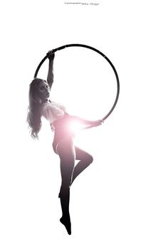 a woman is doing aerial acrobatics with a hoop on her back and arms