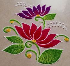 a close up of a flower design on a table top with beads and pearls around the edges