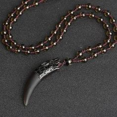 Dramatic looking pendant in the shape of a wolf tooth and topped with wolf heads. Made from natural stone and obsidian (volcanic glass). Available with rope or bead style chains. Pendant size approx - 63 x 14mm (2.5 x 0.5 inches). Chain length approx 60cm (23") Ice Chain, Wolf Tooth Necklace, Black Obsidian Necklace, Wolf Tooth, Wolf Teeth, Obsidian Necklace, Necklace Chain Types, Lucky Jewelry, Wolf Necklace