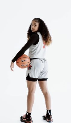 a woman holding a basketball in her right hand