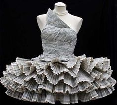 a dress made out of newspapers sitting on top of a mannequin