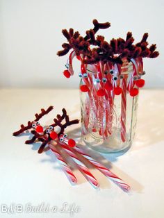 some candy canes are sitting in a glass vase