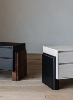 two nightstands sitting next to each other on top of a wooden floor