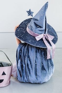 a blue witch hat sitting on top of a bag