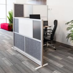 an office cubicle with two chairs and a desk