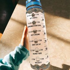 a person holding up a water bottle with the instructions for how to get started on it