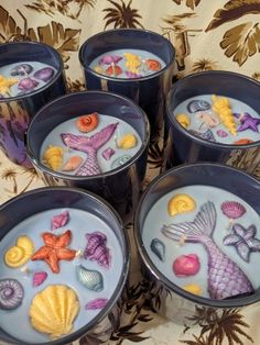 six cups filled with different types of sea animals