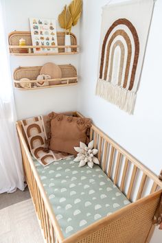 a baby crib in the corner of a room with two shelves on the wall