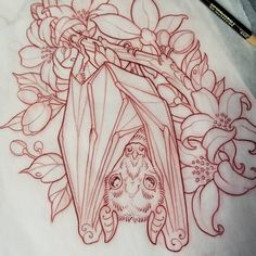 a drawing of a bat with flowers and leaves around it on a piece of paper