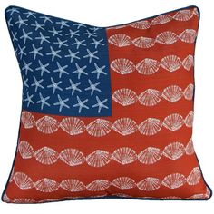 an orange and blue pillow with white stars on the front, and a red background