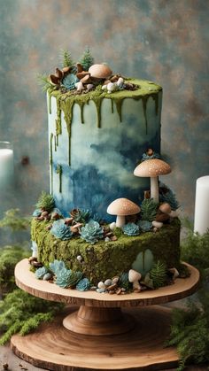 a blue and green cake with mushrooms on it sitting on top of a wooden stand