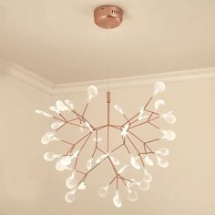 a chandelier hanging from the ceiling in a room with white walls and flooring