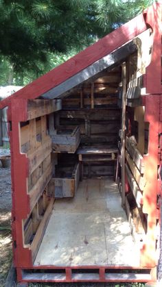 the inside of a red truck with lots of crates in it