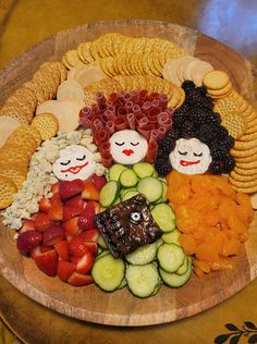 a wooden platter filled with fruit and veggies