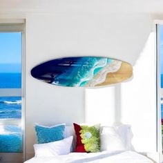 a surfboard mounted to the side of a wall above a bed