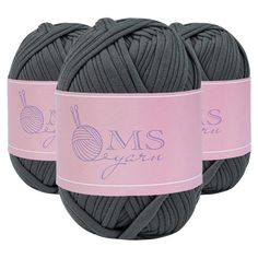 two balls of gray yarn with pink labels