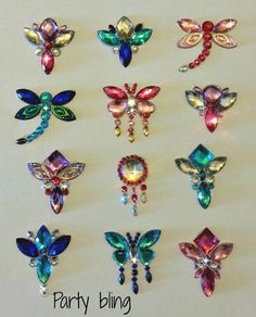 a bunch of different colored glass butterflies on a white surface with the words party bling written below them