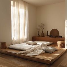 a bed sitting on top of a hard wood floor next to a wooden shelf filled with vases