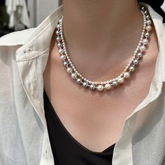 Unleash your bold and daring side with our Double Layered Pearl Necklace! This stunning gift for her will add a touch of sophistication and elegance to any outfit. With its double layered design and lustrous pearls, it's a must-have for any risk-taker looking to add a little adventure to their wardrobe. Material: 18K White Gold Plated Copper Stone: Cubic ZirconiaPearl: High Quality Artificial PearlPearl Size: 48mmLength: 42cm-46cmEmbrace sophistication with our captivating double-layer pearl necklace! Black, gray, white, and champagne pearls intertwine, offering a versatile palette that transitions seamlessly from day to night. Wear it layered for a bold statement or separate the strands for minimalist elegance. Color Pearl Necklace, Pearl Light, Bff Jewelry, Layered Pearl Necklace, Couple Necklaces, Couple Jewelry, Layered Design, Style Korean, Necklace Fashion