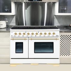 a white stove top oven sitting inside of a kitchen