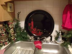 a black plate sitting on top of a kitchen sink